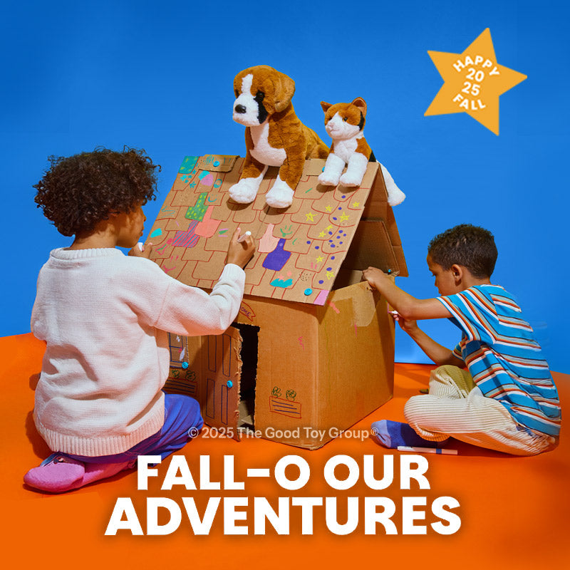 View Our Fall Playbook - Two children playing with a cardboard playset featuring toy animals against a blue sky.